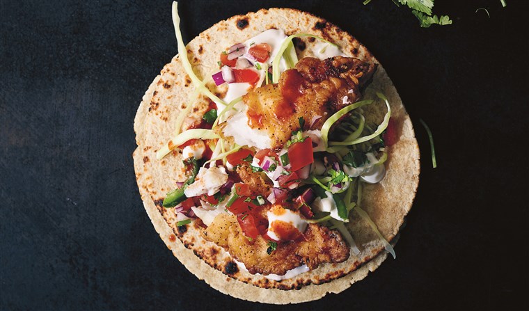 Taqueria-style fish tacos with salsa and lime crema